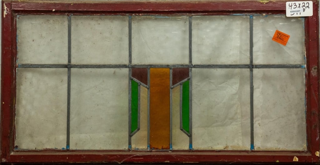 ENGLISH ART DECO STAINED GLASS PANEL: English Art Deco stained glass panel with green, amber, and purple geometric medallion. Approximate dimensions: h. 22", w. 43" Disclaimer: This is an online court ordered bankruptcy sale. Participatin