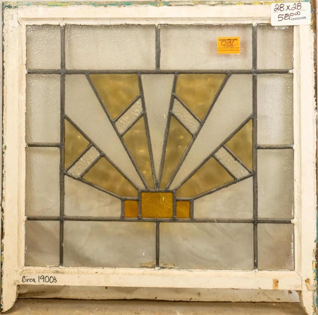 ENGLISH ART DECO STAINED GLASS PANEL: English Art Deco stained glass panel with a geometric amber and chartreuse medallion. Approximate dimensions: h. 28", w. 28" Disclaimer: This is an online court ordered bankruptcy sale. Participating