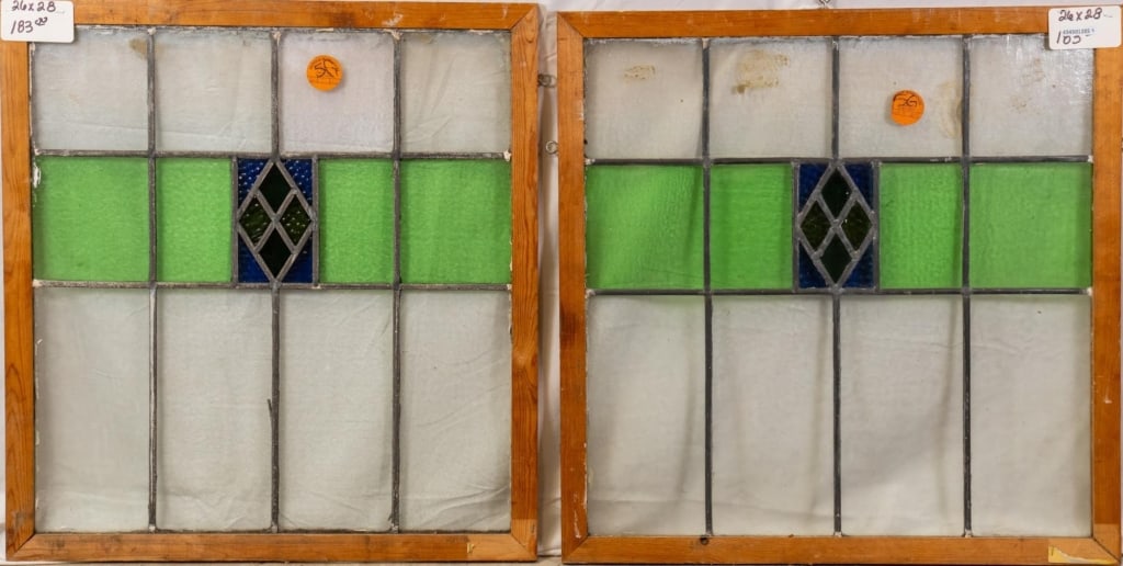PAIR OF CONTINENTAL STAINED GLASS PANELS: Pair of Continental stained glass panels with geometric medallions and blue textured glass accents. Approximate dimensions: h. 28", w. 26" Disclaimer: This is an online court ordered bankruptcy sale.