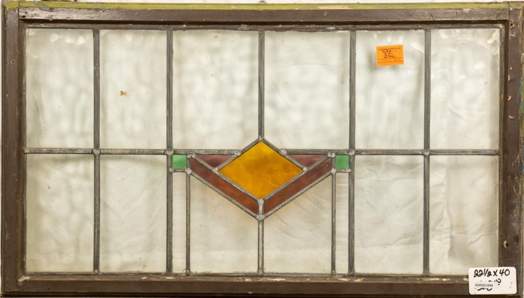 ENGLISH ART DECO STAINED GLASS PANEL: English Art Deco stained glass panel with geometric medallion in yellow, purple, and green. Approximate dimensions: h. 22.5", w. 40" Disclaimer: This is an online court ordered bankruptcy sale. Partic