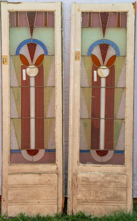 PAIR OF ART DECO LEADED STAINED GLASS DOORS: Pair of Art Deco leaded stained glass doors incorporating opalescent and textured glass elements. Approximate dimensions: h. 82", w. 24" Disclaimer: This is an online court ordered bankruptcy sale. Pa