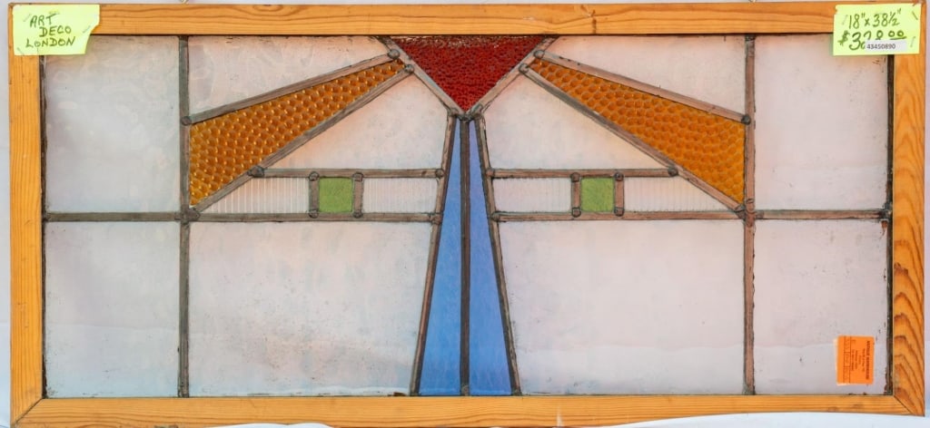 FRENCH ART DECO STAINED GLASS PANEL: French Art Deco stained glass panel with red, amber, and blue geometric motifs. Approximate dimensions: h. 18", w. 38.5" Disclaimer: This is an online court ordered bankruptcy sale. Participating bidd