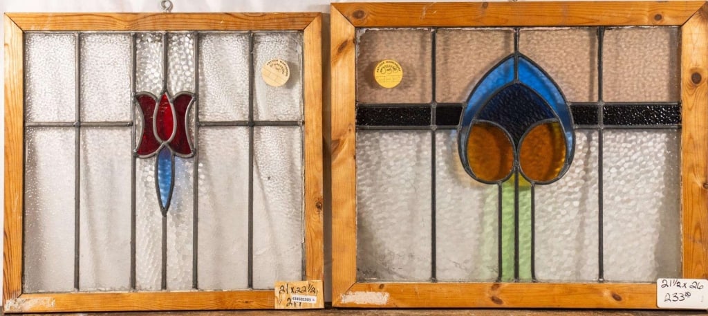 TWO CONTINENTAL ART NOUVEAU STAINED GLASS PANELS: Two Continental Art Nouveau stained glass panels, one with a floral medallion and the other with a heart-shaped medallion. Approximate dimensions: h. 21.5", w. 26" Disclaimer: This is an online court