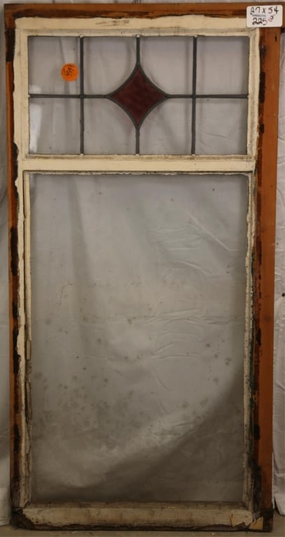 ANTIQUE ENGLISH STAINED GLASS PANEL: Antique English stained glass panel with purple rhombic stained glass accents. Approximate dimensions: h. 54", w. 27" Disclaimer: This is an online court ordered bankruptcy sale. Participating bidders