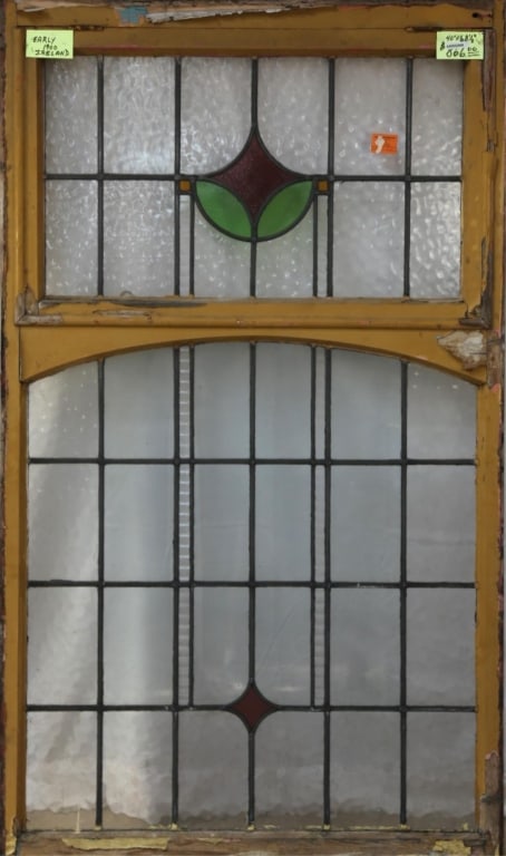 IRISH ART DECO STAINED GLASS PANEL: Irish Art Deco stained glass panel with purple, amber, and green medallion, colorless leaded glass panels. Approximate dimensions: h. 68.5", w. 40" Disclaimer: This is an online court ordered bankrupt