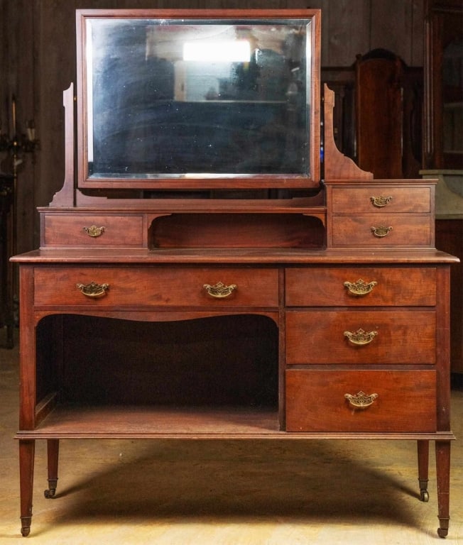 ENGLISH PLUM PUDDING MAHOGANY VANITY: English plum pudding mahogany vanity with brass castered and graduated legs. Approximate dimensions: h. 60", w. 49", d. 22" Disclaimer: This is an online court ordered bankruptcy sale. Participating b