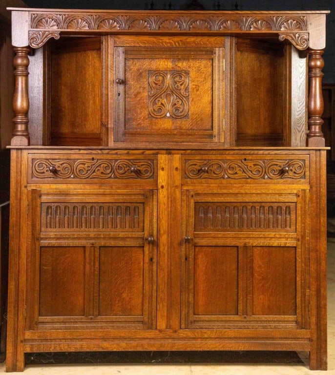 FRENCH OAK COURT CUPBOARD: French oak court cupboard with inset carved panels and carved columns. Approximate dimensions: h. 60", w. 54", d. 20" Disclaimer: This is an online court ordered bankruptcy sale. Participating bidders