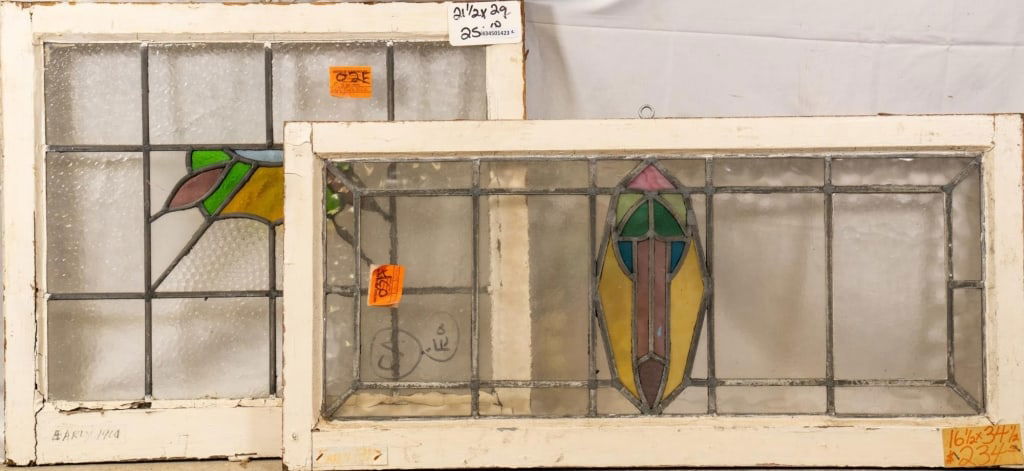 TWO CONTINENTAL ART NOUVEAU STAINED GLASS PANELS: Two Continental Art Nouveau stained glass panels with multicolored stained glass accents. Approximate dimensions: h. 21.5", w. 29" Disclaimer: This is an online court ordered bankruptcy sale. Particip