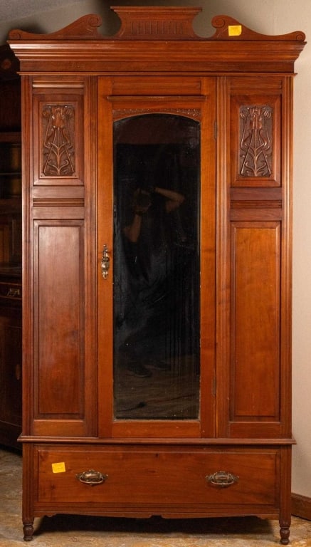 FRENCH ART NOUVEAU BEVELED ARMOIRE: French Art Nouveau beveled mirror armoire with carved inset panels, scroll bun bonnet, and turned feet. Approximate dimensions: h. 83", w. 44", d. 19" Disclaimer: This is an online court ordered bankr