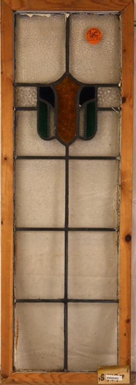 ANTIQUE IRISH STAINED GLASS PANEL: Antique Irish stained glass panel with shield-form medallion in amber, blue, and green. Approximate dimensions: h. 42", w. 14" Disclaimer: This is an online court ordered bankruptcy sale. Participatin