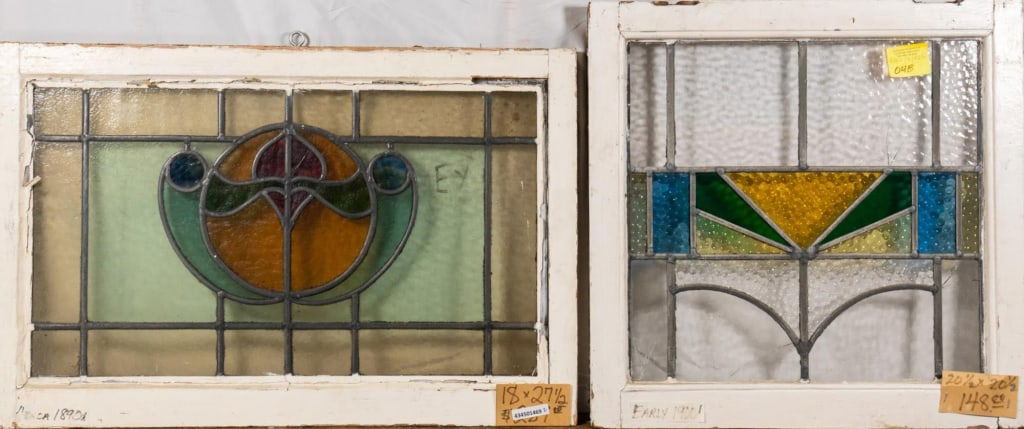 TWO FRENCH STAINED GLASS PANELS: Two French stained glass panels with floral and geometric motifs. Approximate dimensions: h. 18", w. 27.5" Disclaimer: This is an online court ordered bankruptcy sale. Participating bidders must have