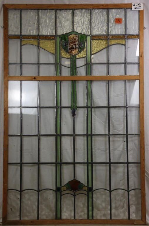 IRISH ART DECO STAINED GLASS PANEL: Irish Art Deco stained glass panel with shield-form medallion. Approximate dimensions: h. 66", w. 43" Disclaimer: This is an online court ordered bankruptcy sale. Participating bidders must have a cre