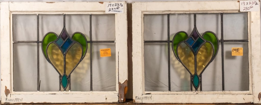 PAIR OF FRENCH ART NOUVEAU STAINED GLASS PANELS: Pair of French Art Nouveau stained glass panels with heart-shaped floral medallions. Approximate dimensions: h. 19", w. 23.5" Disclaimer: This is an online court ordered bankruptcy sale. Participating