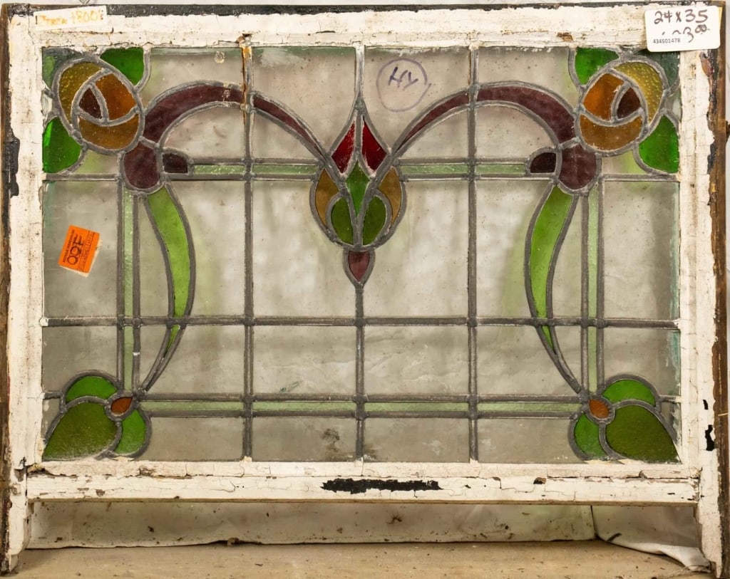 FRENCH ART NOUVEAU STAINED GLASS PANEL: French Art Nouveau stained glass panel with a floral and botanical motif and floral corner details. Approximate dimensions: h. 24", w. 35" Disclaimer: This is an online court ordered bankruptcy sale.