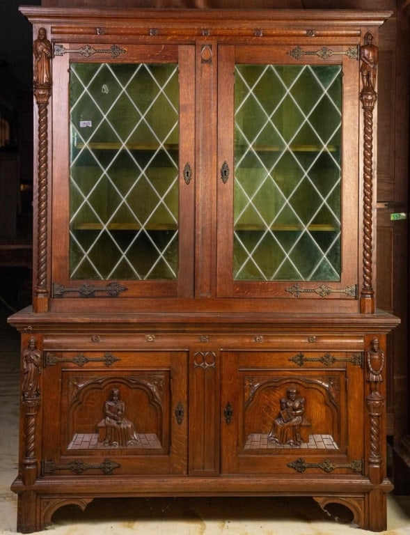 FRENCH RENAISSANCE REVIVAL STAINED GLASS VITRINE C: French Renaissance Revival stained glass vitrine cabinet, with hand-forged hinges, figural inset carved panels, and leaded chartreuse glass. Approximate dimensions: h. 66", w. 49", d. 19" Disclaimer: