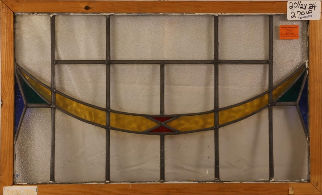 ENGLISH ART DECO STAINED GLASS PANEL: English Art Deco stained glass panel with blue, green, red, and canary yellow stained glass details. Approximate dimensions: h. 20.5", w. 33" Disclaimer: This is an online court ordered bankruptcy sal