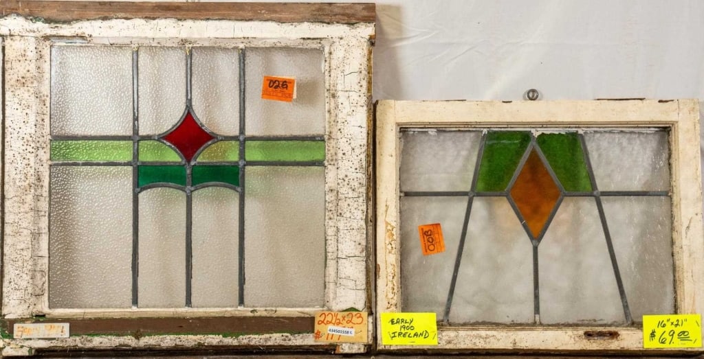 TWO CONTINENTAL STAINED GLASS PANELS: Two Continental stained glass panels with geometrical multicolored accents. Approximate dimensions: h. 22.5", w. 23" Disclaimer: This is an online court ordered bankruptcy sale. Participating bidders
