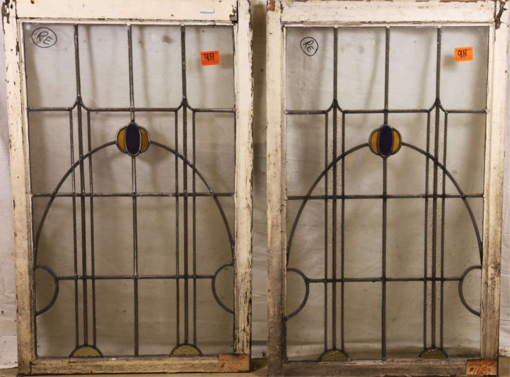 PAIR OF ENGLISH ART DECO STAINED GLASS PANELS: Pair of English Art Deco stained glass panels with yellow and purple geometric medallion. Approximate dimensions: h. 42.5", w. 26.5" Disclaimer: This is an online court ordered bankruptcy sale. Partic