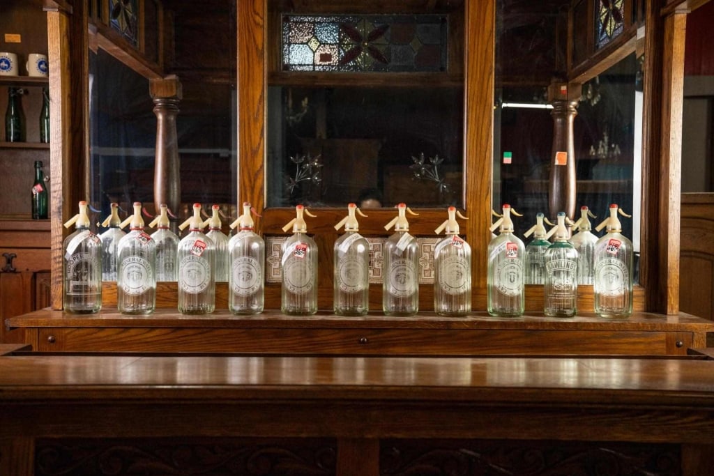 11 ENGLISH PUB SELTZER GLASS BOTTLES: Eleven English pub seltzer glass bottles. Disclaimer: This is an online court ordered bankruptcy sale. Participating bidders must have a credit card on file with Live Auctioneers. Credit cards will be
