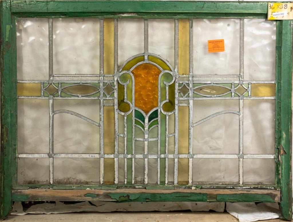 ENGLISH ART NOUVEAU STAINED GLASS PANEL: English Art Nouveau stained glass panel with an amber, chartreuse and green medallion. Approximate dimensions: h. 28", w. 36" Disclaimer: This is an online court ordered bankruptcy sale. Participating