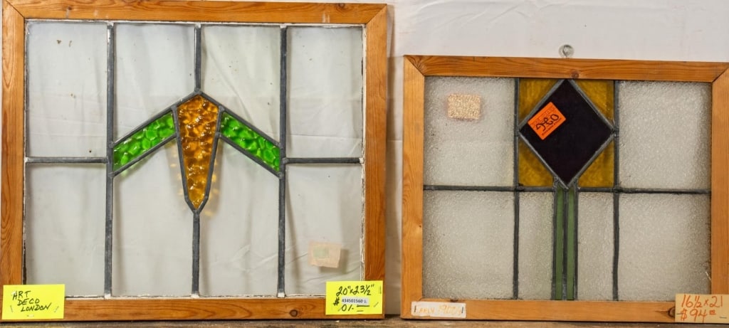 TWO ENGLISH STAINED GLASS PANELS: Two English stained glass panels with geometrical multicolored accents. Approximate dimensions: h. 20, w. 23.5" Disclaimer: This is an online court ordered bankruptcy sale. Participating bidders must