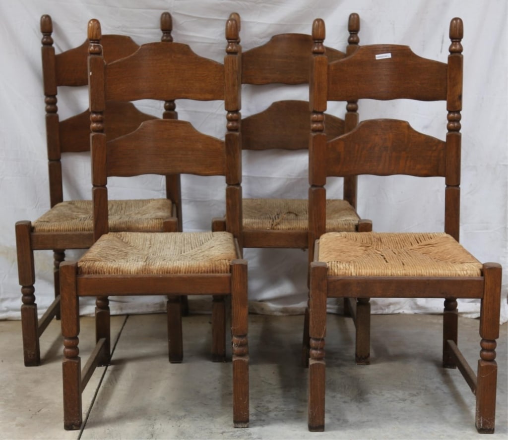 SET OF 4 ENGLISH OAK RUSH SEAT CHAIRS: Set of four English oak rush seat chairs with carved finials and legs. Approximate dimensions: h. 41.5", w. 19", d. 19" Disclaimer: This is an online court ordered bankruptcy sale. Participating bidde