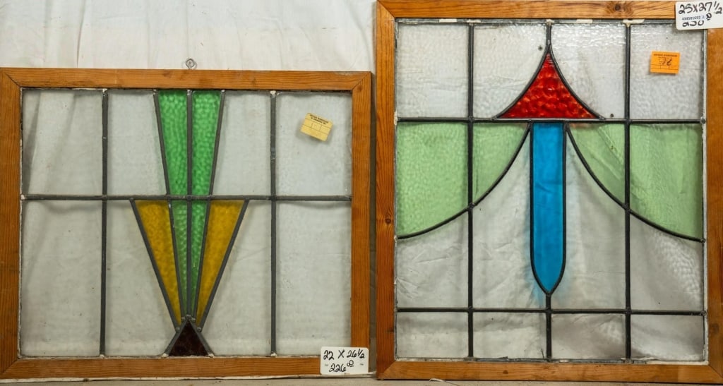 TWO ANTIQUE CONTINENTAL STAINED GLASS PANELS: Two antique Continental stained glass panels with red, green, amber, and yellow stained glass accents. Approximate dimensions: h. 27.5", w. 25" Disclaimer: This is an online court ordered bankruptcy s