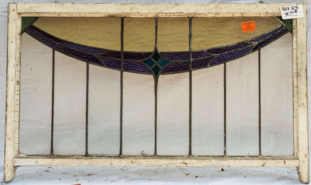 FRENCH ART NOUVEAU STAINED GLASS PANEL: French Art Nouveau stained glass panel with purple ribbon, blue rhombic central detail, and colorless leaded glass panels. Approximate dimensions: h. 25", w. 46" Disclaimer: This is an online court or