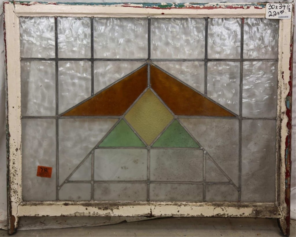 FRENCH ART DECO STAINED GLASS PANEL: French Art Deco stained glass panel with triangle amber, canary yellow, and green medallion. Approximate dimensions: h. 30", w. 39.5" Disclaimer: This is an online court ordered bankruptcy sale. Parti