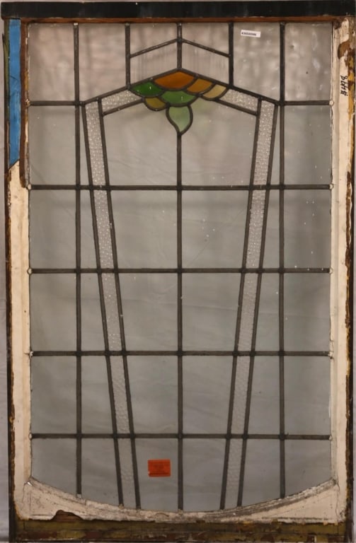 ENGLISH ART DECO STAINED GLASS PANEL: English Art Deco stained glass panel with geometric medallion in green and amber, with colorless leaded glass panels. Approximate dimensions: h. 51", w. 31.5" Disclaimer: This is an online court order
