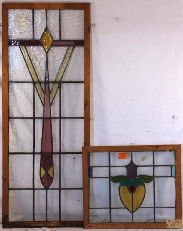 TWO CONTINENTAL STAINED GLASS PANELS: Two Continental stained glass panels, one with geometric medallion in amber and purple, another one with heart-shaped floral motif medallion. Approximate dimensions: h. 51.5", w. 20" Disclaimer: This
