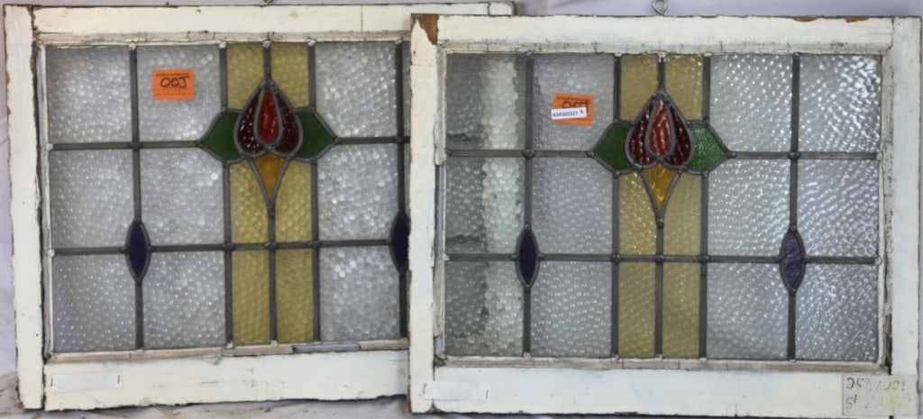 TWO ENGLISH STAINED GLASS PANELS: Two English stained glass panels with floral medallions and amber and purple accents. Approximate dimensions: h. 25.5", w. 30" Disclaimer: This is an online court ordered bankruptcy sale. Participatin