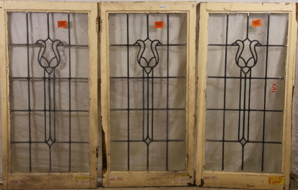 SET OF 3 ANTIQUE FRENCH LEADED GLASS PANELS: Set of three antique French leaded glass panels, each with floral motif and textured colorless leaded glass accents. Approximate dimensions: h. 22", w. 44" Disclaimer: This is an online court ordered 