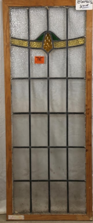 ANTIQUE ENGLISH STAINED GLASS PANEL: Antique English stained glass panel with amber and green stained glass medallion and canary yellow textured glass detail. Approximate dimensions: h. 46.5", w. 18.5" Disclaimer: This is an online court