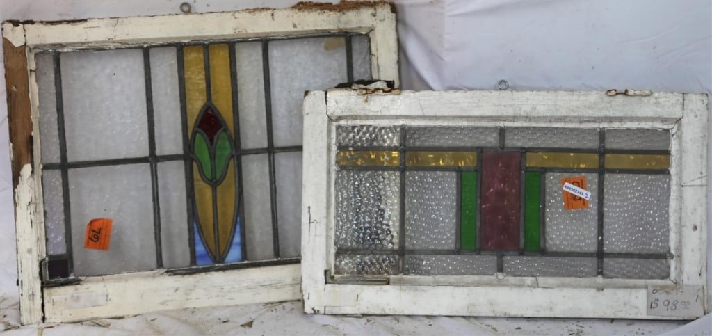 TWO CONTINENTAL STAINED GLASS PANELS: Two Continental stained glass panels with multicolored stained glass accents. Approximate dimensions: h. 19", w. 25" Disclaimer: This is an online court ordered bankruptcy sale. Participating bidders