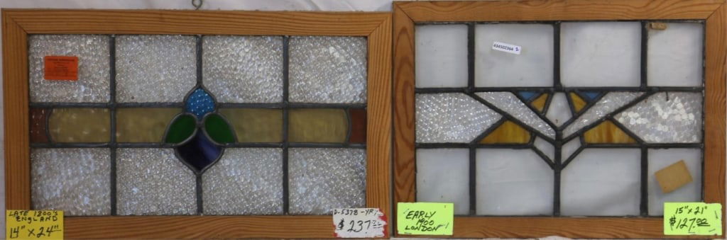 TWO ENGLISH STAINED GLASS PANELS: Two English stained glass panels, one featuring a refined floral medallion and the other an abstract geometric medallion in multicolored glass. Approximate dimensions: h. 15", w. 21" Disclaimer: This