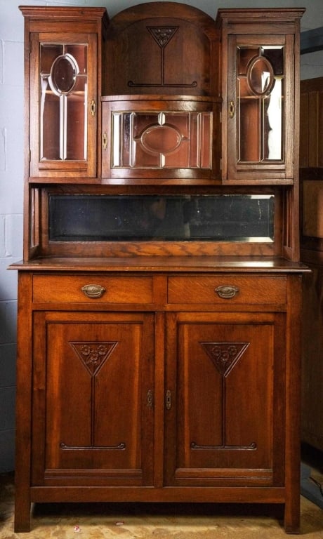 FRENCH ART NOUVEAU VINTRINE BUFFET: French Art Nouveau vitrine buffet with beveled mirror backsplash, beveled glass cabinet doors, and inset carved panels. Approximate dimensions: h. 89", w. 46", d. 19" Disclaimer: This is an online cou