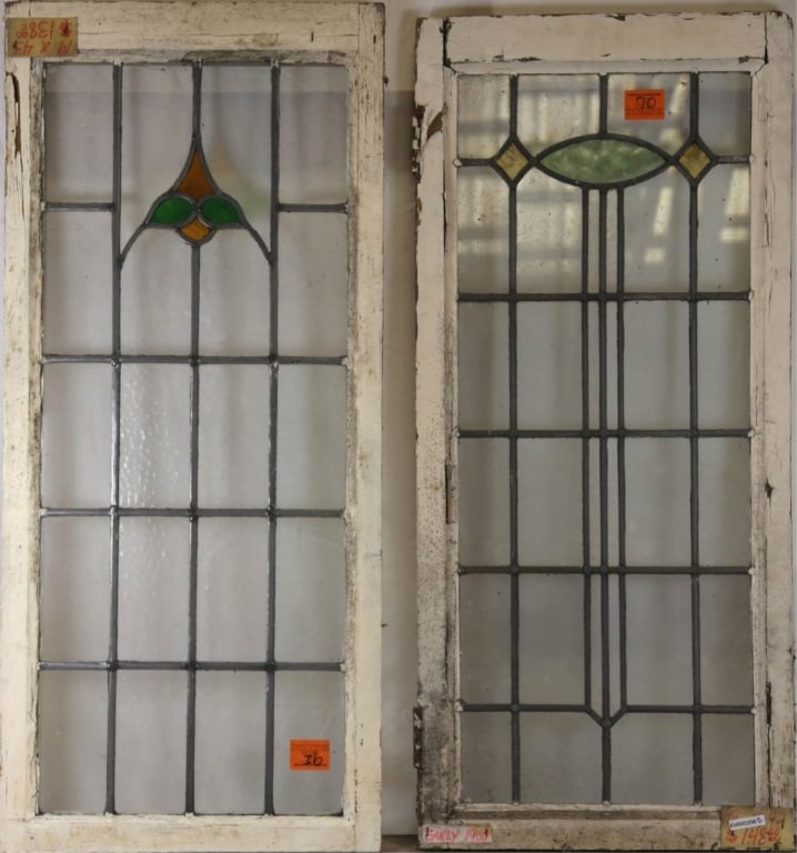 TWO ANTIQUE CONTINENTAL STAINED GLASS PANELS: Two antique Continental stained glass panels with colorless leaded glass panels and amber, green, and yellow medallions. Approximate dimensions: h. 42", w. 19" Disclaimer: This is an online court orde