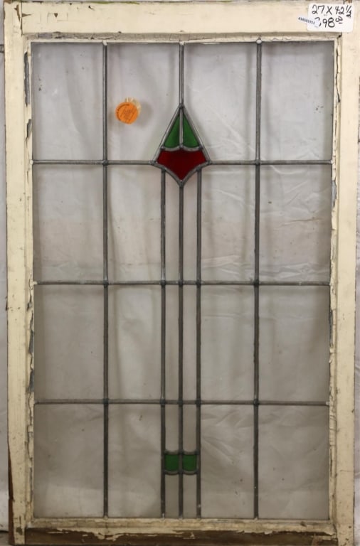 ENGLISH ART DECO STAINED GLASS PANEL: English Art Deco stained glass panel with geometric medallion in red and green. Approximate dimensions: h. 42.5", w. 27" Disclaimer: This is an online court ordered bankruptcy sale. Participating bidd