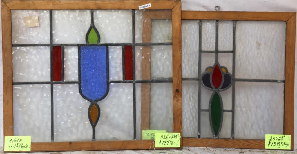 TWO CONTINENTAL STAINED GLASS PANELS: Two Continental stained glass panels with multicolored stained glass accents. Approximate dimensions: h. 21.5", w. 25.5" Disclaimer: This is an online court ordered bankruptcy sale. Participating bidd
