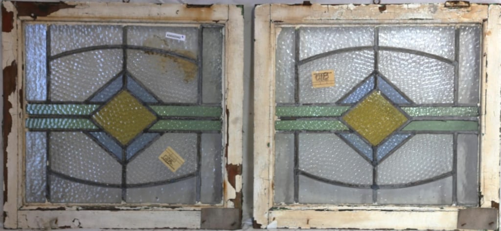 PAIR OF ENGLISH ART DECO STAINED GLASS PANELS: Pair of English Art Deco stained glass panels with geometric medallions in yellow, blue, and green. Approximate dimensions: h. 20.5", w. 21" Disclaimer: This is an online court ordered bankruptcy sale