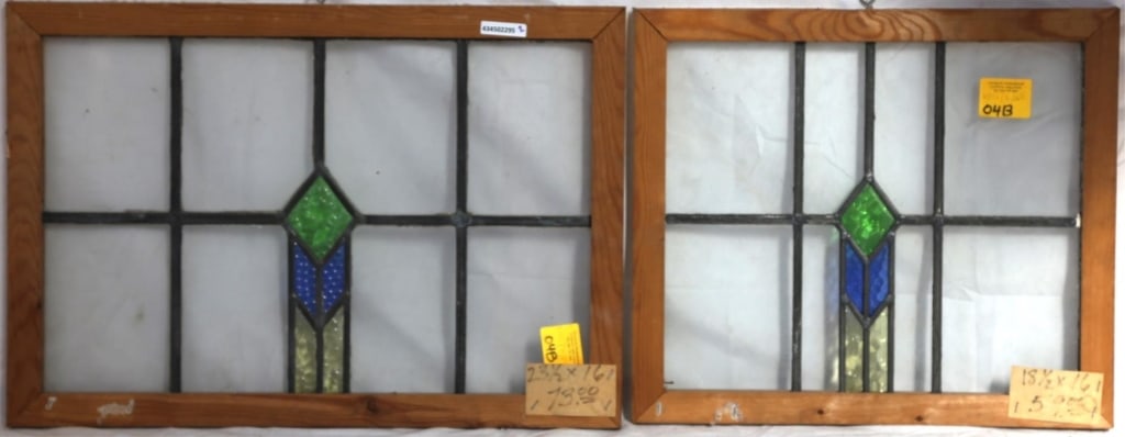 PAIR OF IRISH ART DECO STAINED GLASS PANELS: Pair of Irish Art Deco stained glass panels with a geometric medallion in green, blue, and yellow stained glass. Approximate dimensions: h. 16", w. 23.5" Disclaimer: This is an online court ordered ba