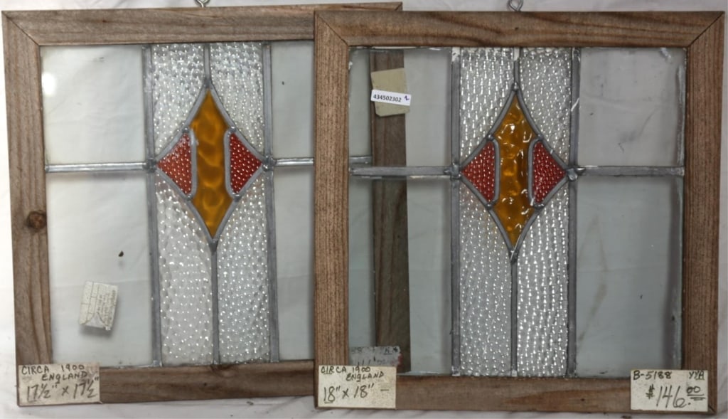 PAIR OF ENGLISH ART DECO STAINED GLASS PANELS: Pair of English Art Deco stained glass panels with amber and red rhombic medallions. Approximate dimensions: h. 18", w. 18" Disclaimer: This is an online court ordered bankruptcy sale. Participating b