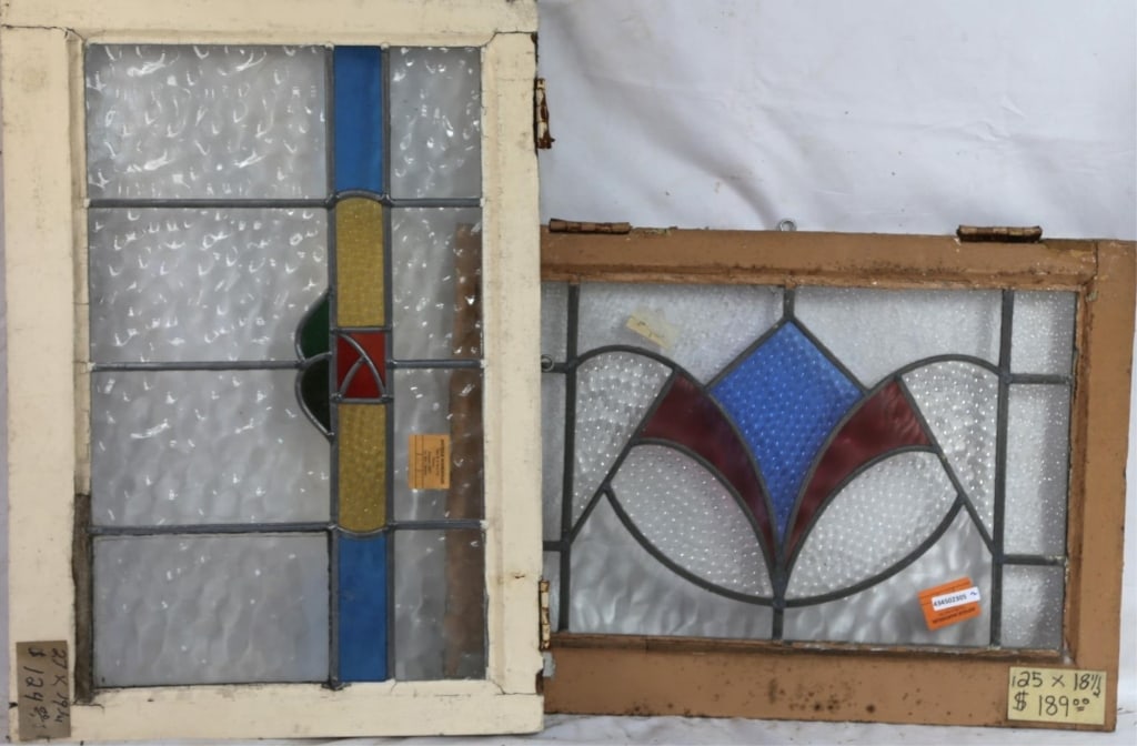 TWO ENGLISH STAINED GLASS PANELS: Two English stained glass panels with geometric multicolored stained glass elements. Approximate dimensions: h. 19.5", w. 27" Disclaimer: This is an online court ordered bankruptcy sale. Participating