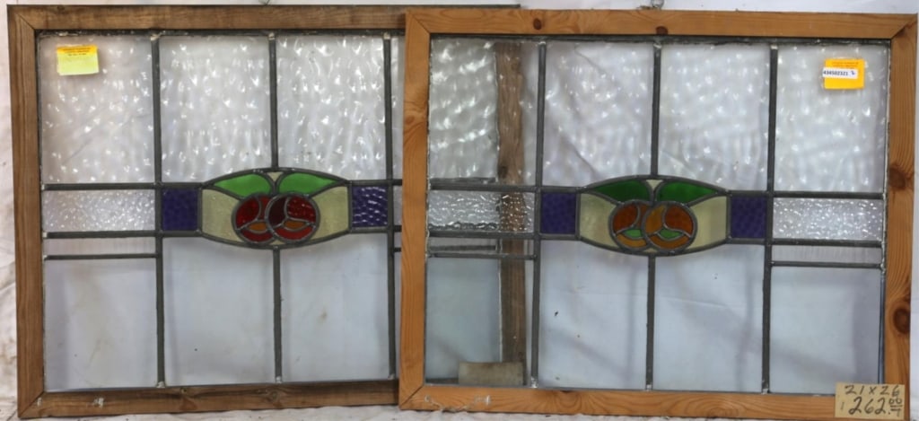 PAIR OF FRENCH STAINED GLASS PANELS: Pair of French stained glass panels with floral medallions, one in red and the other in orange, with purple accents and textured colorless leaded glass panels. Approximate dimensions: h. 21", w. 26" D