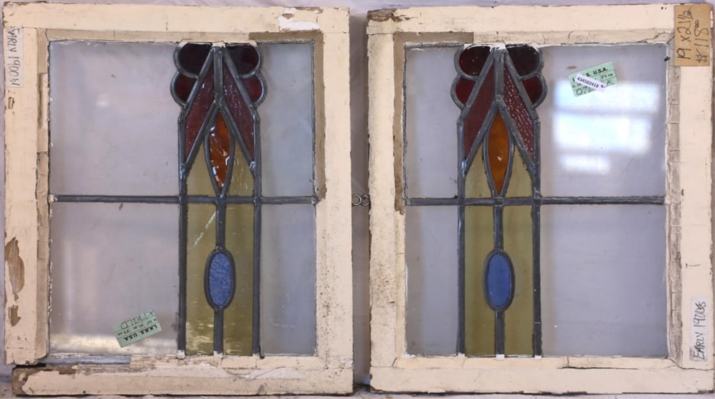 PAIR OF ENGLISH STAINED GLASS PANELS: Pair of English stained glass panels with abstract medallions in red, purple, amber, yellow, and blue. Approximate dimensions: h. 21.5", w. 19" Disclaimer: This is an online court ordered bankruptcy s