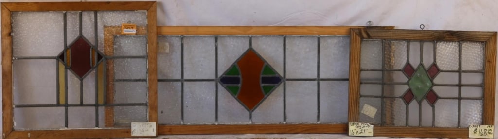 THREE ENGLISH STAINED GLASS PANELS: Three English stained glass panels with multicolored stained glass medallions. Approximate dimensions: h. 16", w. 43" Disclaimer: This is an online court ordered bankruptcy sale. Participating bidders