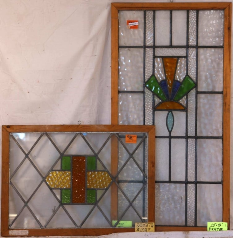 TWO CONTINENTAL STAINED GLASS PANELS: Two Continental stained glass panels with geometric multicolored stained glass medallions. Approximate dimensions: h. 42", w. 22" Disclaimer: This is an online court ordered bankruptcy sale. Participa