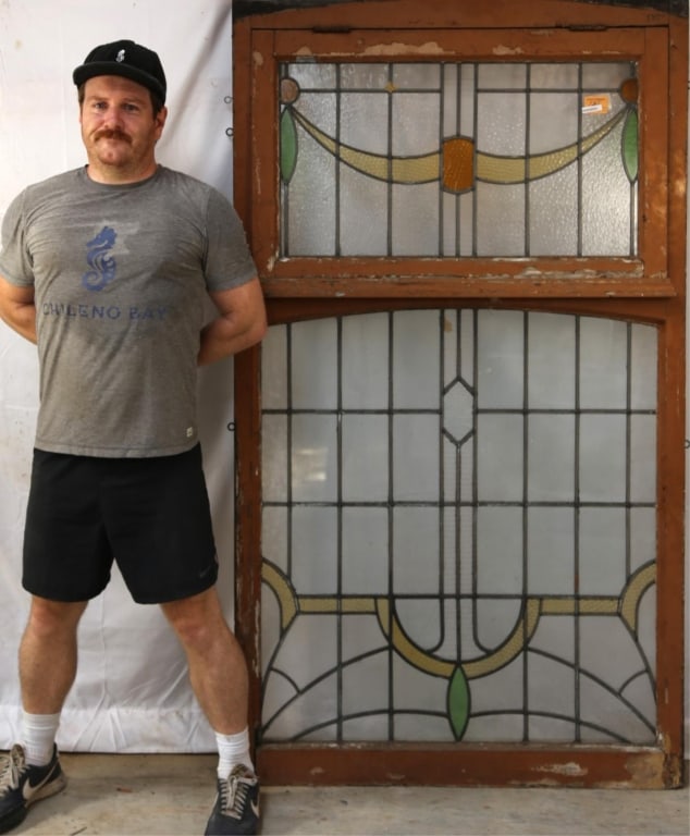 ANTIQUE CONTINENTAL STAINED GLASS PANEL: Antique Continental stained glass panel with garland motif and central textured amber glass element. Approximate dimensions: h. 71", w. 41" Disclaimer: This is an online court ordered bankruptcy sale.