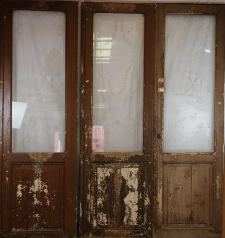 SET OF 3 19TH C. DUTCH ETCHED GLASS DOORS: Dutch, 19th century. Set of three etched glass doors, two with rustic scene panels and one central panel with floral and botanical motif. Approximate dimensions: each: h. 99", w. 30.5" Disclaimer: Thi